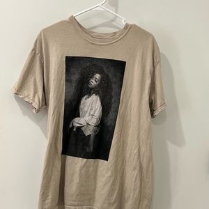 A knit tee featuring a crew neck, front H.E.R. graphic, dropped short sleeves.